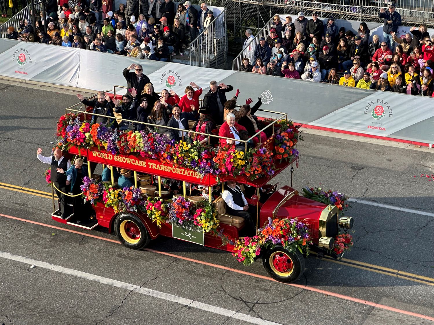 PHOTO: Bill Glazier | The South Pasadenan | Tournament of Roses President Alex Aghajanian, wearing red coat, is joined by family and friends aboard colorful vehicle.