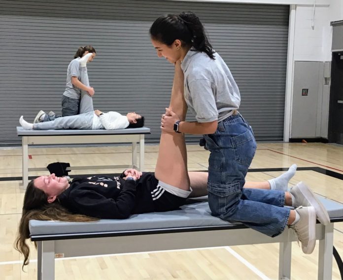 PHOTO: provided by SPUSD | The South Pasadenan | SPHS Advanced Sports Medicine students treat and stretch student athletes and staff during the inaugural Athlete Recovery Day.