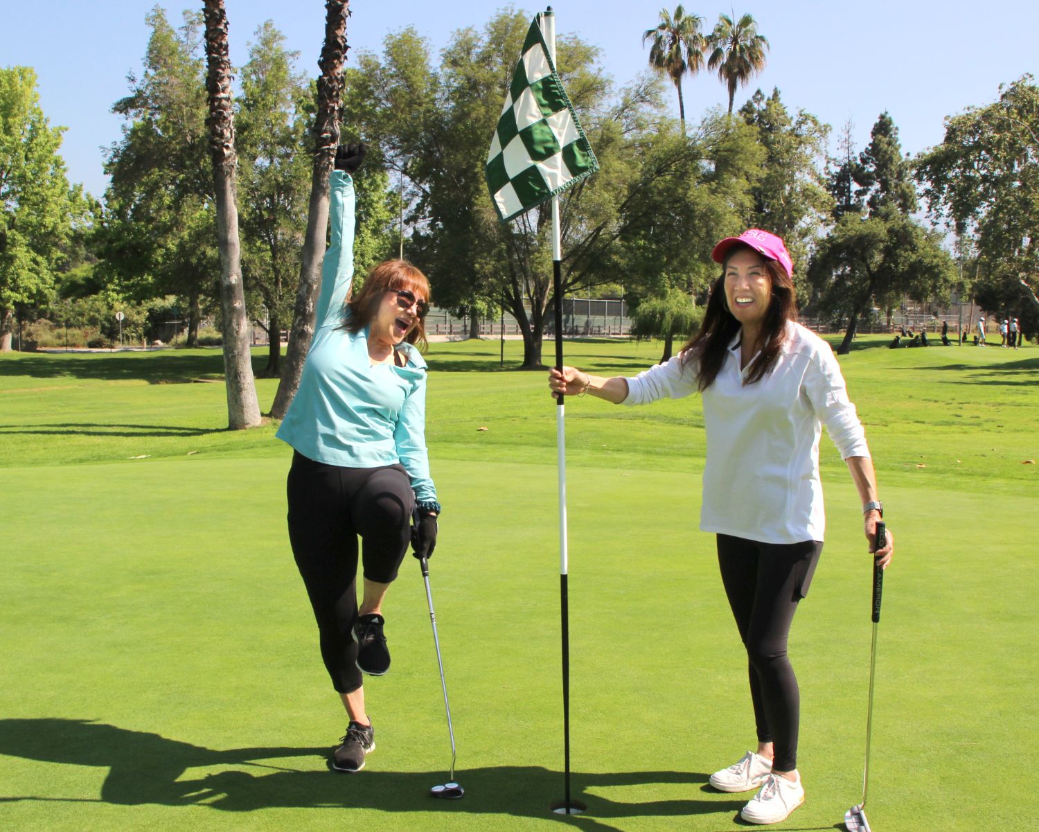 PHOTO: Henk Friezer | The South Pasadenan | Mary Genovia (L) and Sharon Oda celebrate at a hole at the golf tournament. They represent the Woman’s Club of South Pasadena and Alhambra High School alumni.