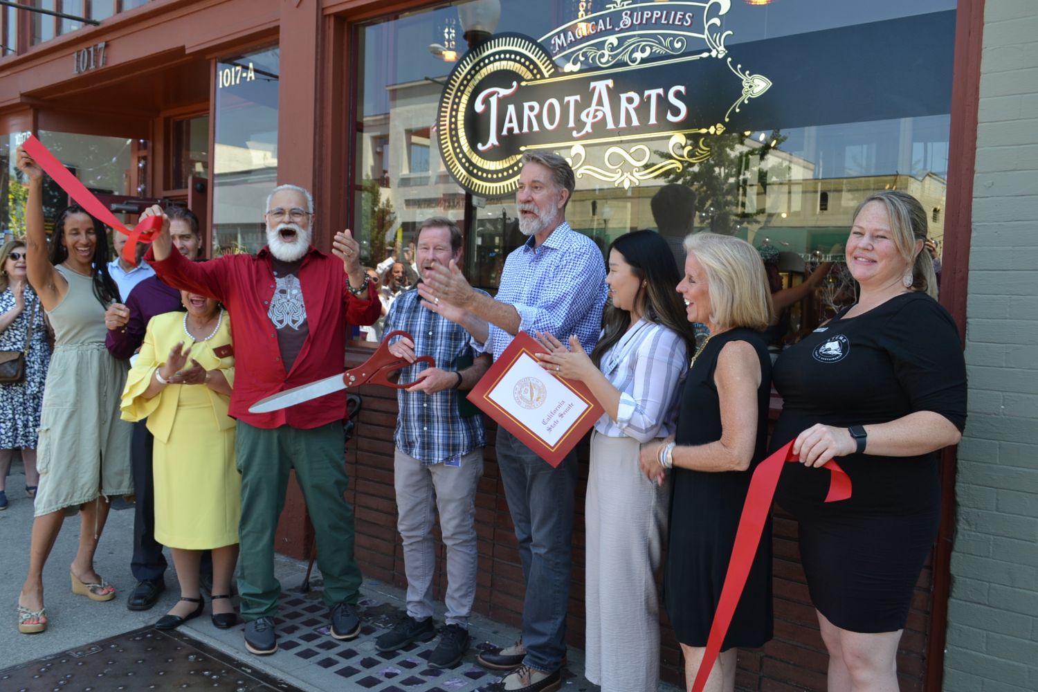 PHOTO: Alisa Hayashida | The South Pasadenan | Tarot Arts celebrates its grand opening with a ribbon cutting. Pictured l-r: Chamber Board Member Karla Thompson, City Councilmember Evelyn Zniemer, City Councilmember Michael Cacciotti, Tarot Arts owner Willaim Toro, Mayor Jon Primuth, Tarot Arts owner Phillip Gibson, Erica Nam from Anthony Portantino's office, City Councilmember Janet Braun, and Chamber Ambassador Chantal Garcia.