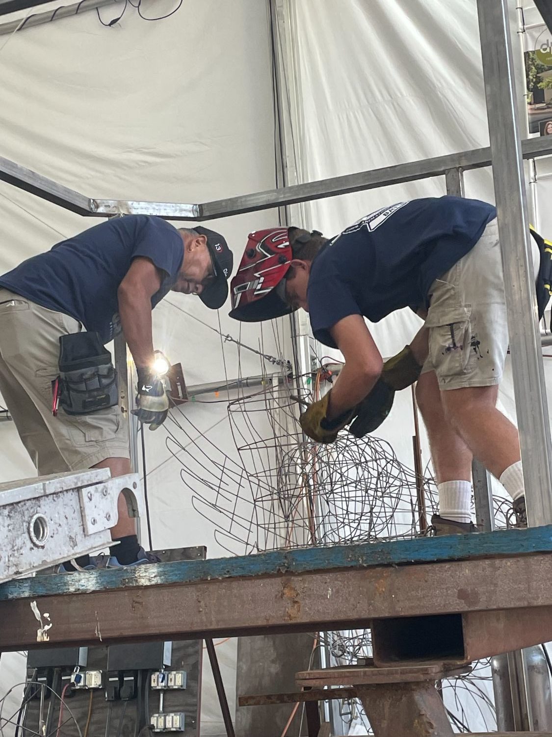PHOTO: Sally Kilby | The South Pasadenan | Volunteer construction crew members (left to right) Dave Martinez and Jeremy Bruce build the platform for the elephant that will appear with other animals on the “Boogie Fever” float at the Sept. 23 workday. 