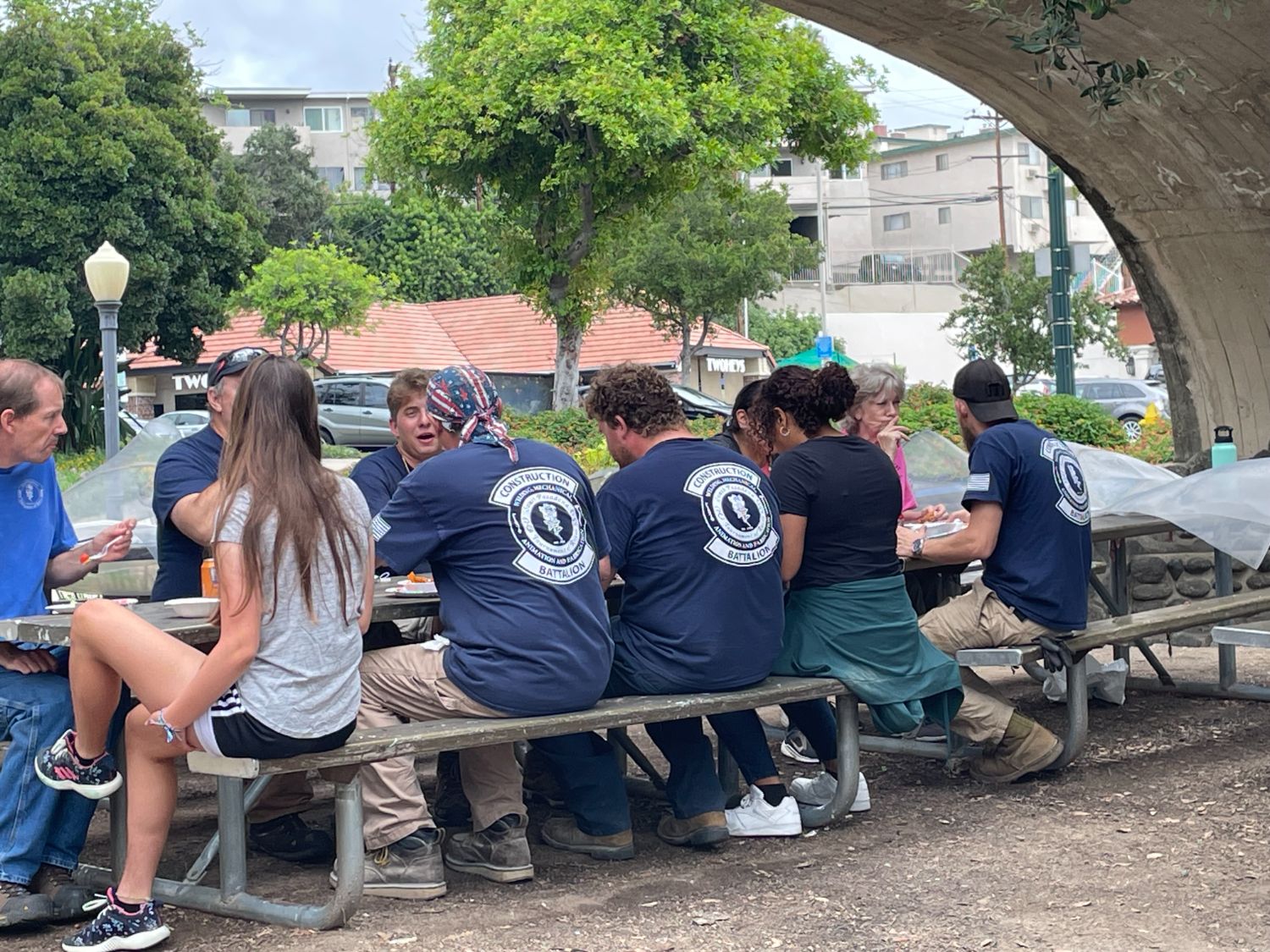 PHOTO: provided by SPTOR | The South Pasadenan | Work crew at lunch under the Oaklawn Bridge at the War Memorial Building tent site. 