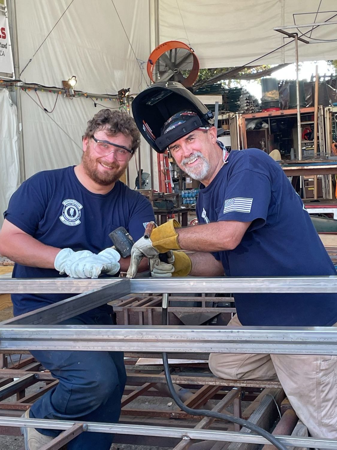 PHOTO: provided by SPTOR | The South Pasadenan | SPTOR construction crew members Brandon Carlson (left) and Brant Dunlap work on preparing the base for a vintage turntable that will appear on the 2024 South Pasadena float. 