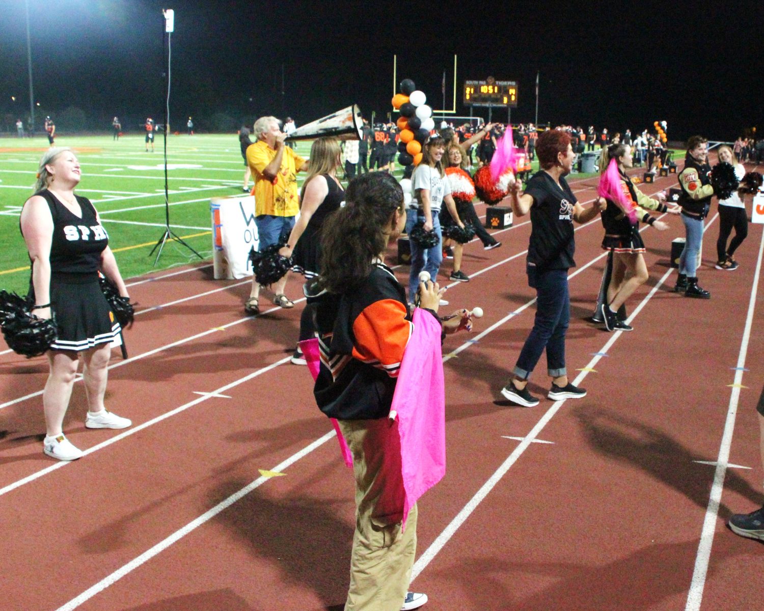 PHOTO: Henk Friezer | The South Pasadenan | Alumni join current SPHS cheerleaders on the field for Homecoming 2023.