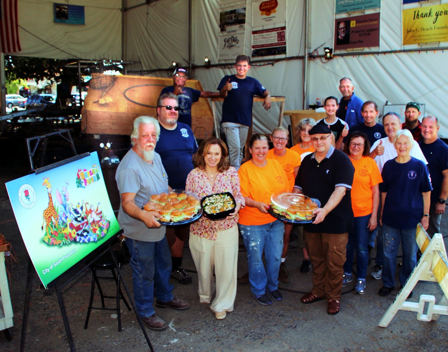 PHOTO: Henk Friezer | The South Pasadenan | Twohey’s Restaurant brings lunch to the South Pasadena Tournament of Roses’ Float work crew on Saturday, Oct. 21 at the float site at the War Memorial Building. Owners Tanya Christos (front, second from left) and Greg Mallis (front, wearing black shirt and holding platter) are providing complementary lunches for the crew during the float building and decoration season.
