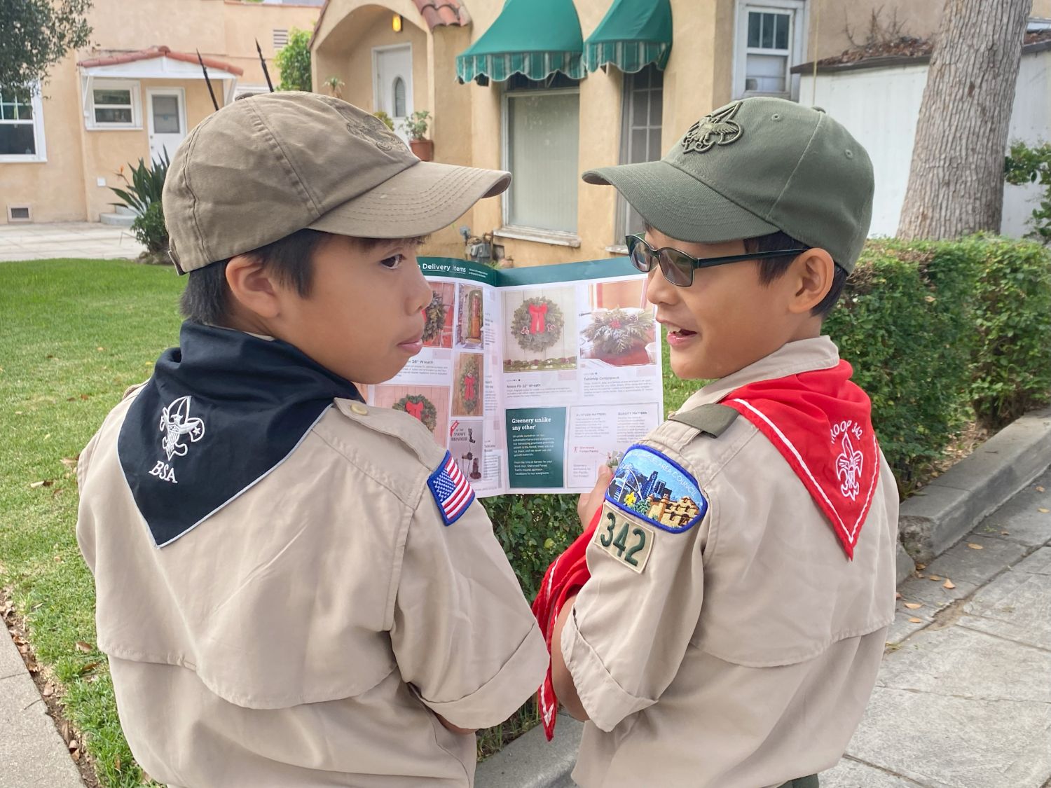 PHOTO: provided by Troop 342 | The South Pasadenan | Benji Beteta of Troop 7 in black neckerchief and Philip Kwak of Troop 342 in red neckerchief looking at a product flyer.