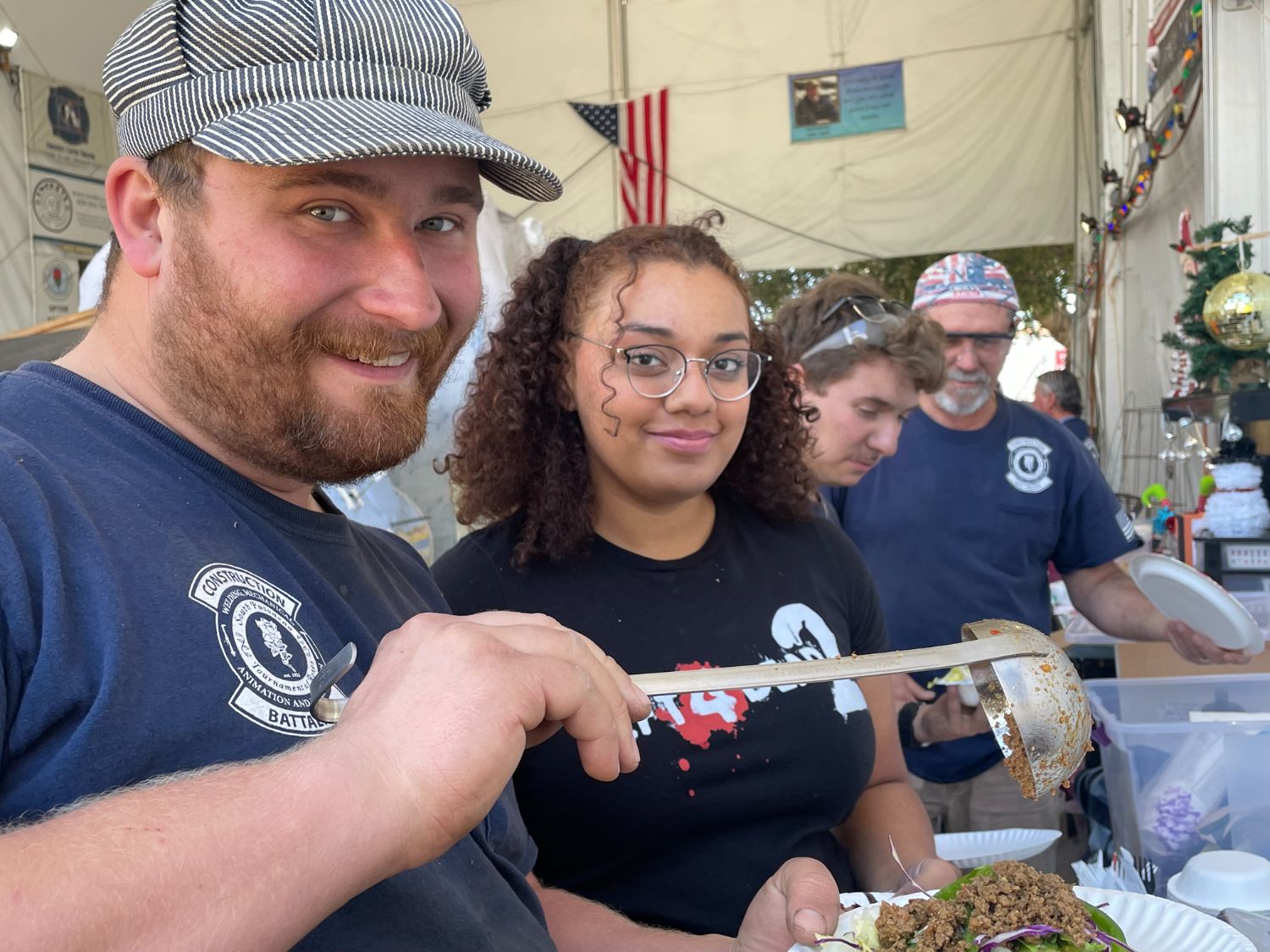 PHOTO: Sally Kilby | The South Pasadenan | Brandon Carlson, Alexandra Strong and other work crew members help themselves to the taco salad lunch provided by Hi-Life. 