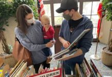PHOTO: Nancy Lem | South Pasadenan.com News | Ben and Michelle Corser shop for books for their son at the Holiday Book Sale.