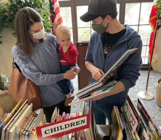 PHOTO: Nancy Lem | South Pasadenan.com News | Ben and Michelle Corser shop for books for their son at the Holiday Book Sale.